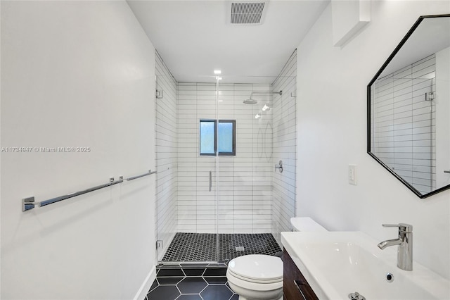 full bathroom featuring visible vents, toilet, tile patterned floors, vanity, and a shower stall