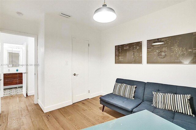 156 NW 90th St, El Portal, FL 33150 - sitting room featuring wood finished floors and baseboards
