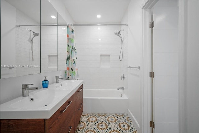 full bath featuring double vanity, a sink, and shower / bath combo with shower curtain