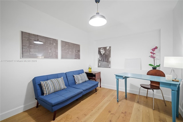 living room featuring baseboards and wood finished floors