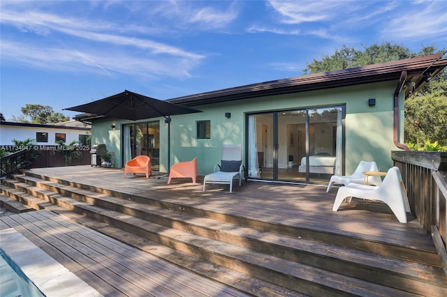 wooden deck featuring a grill