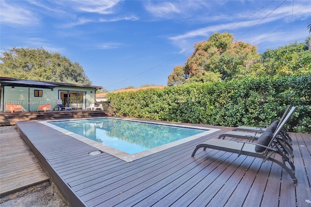 view of pool with a fenced in pool and a wooden deck