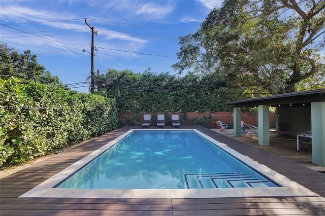 view of pool with a fenced in pool, a fenced backyard, and a deck