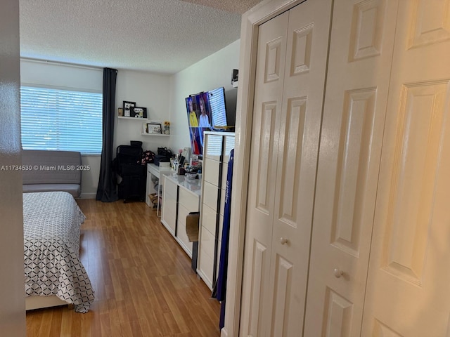 bedroom featuring a textured ceiling and light wood-type flooring