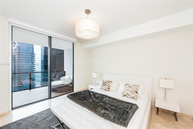 bedroom featuring light tile patterned flooring, a wall of windows, and access to outside