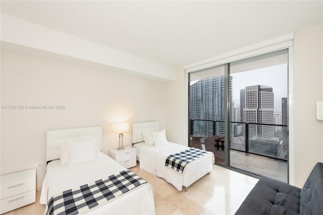 bedroom with access to exterior and a wall of windows