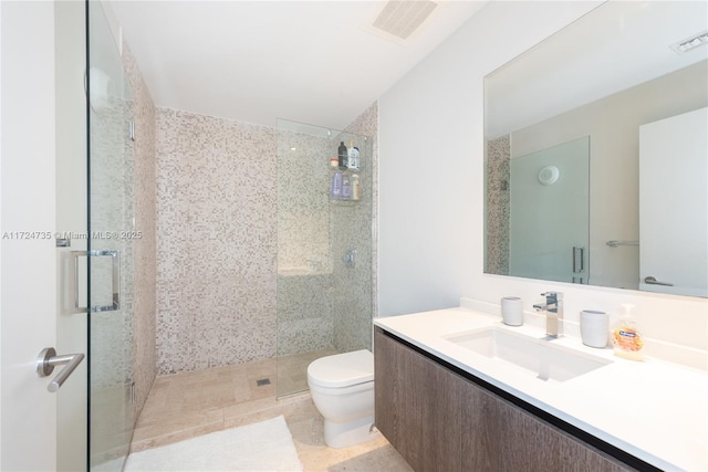 bathroom featuring vanity, an enclosed shower, and toilet