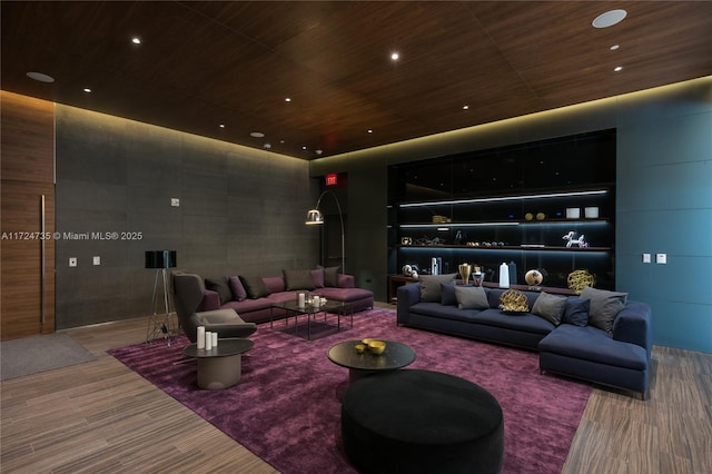 home theater featuring tile walls and wooden ceiling