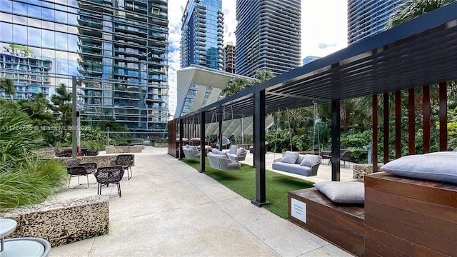 exterior space with outdoor lounge area and a pergola