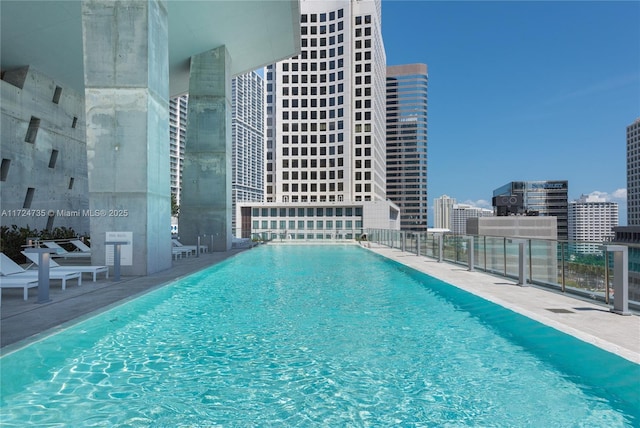 view of pool featuring a beach view