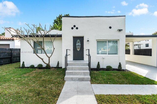 view of front of home featuring central AC unit and a front lawn