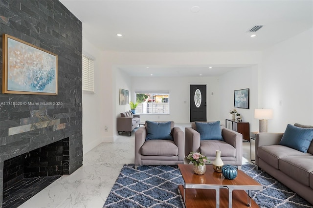 living room featuring a large fireplace, visible vents, baseboards, marble finish floor, and recessed lighting