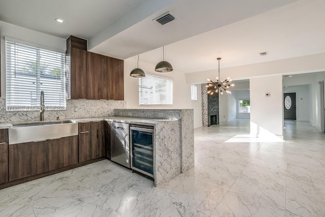 kitchen featuring visible vents, a sink, dark brown cabinetry, beverage cooler, and dishwasher