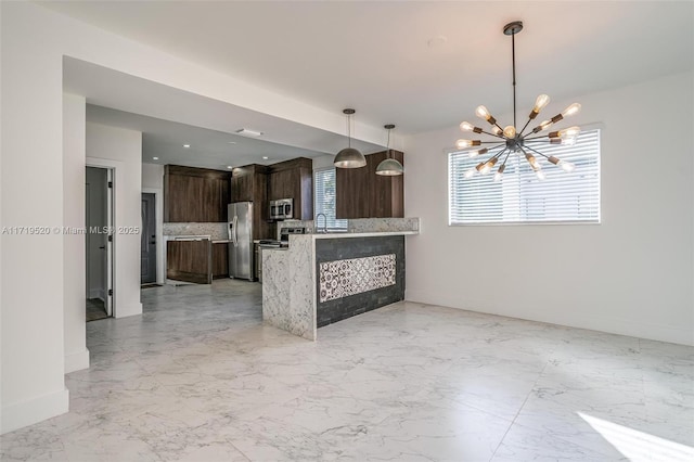 kitchen featuring a peninsula, marble finish floor, appliances with stainless steel finishes, dark brown cabinets, and backsplash