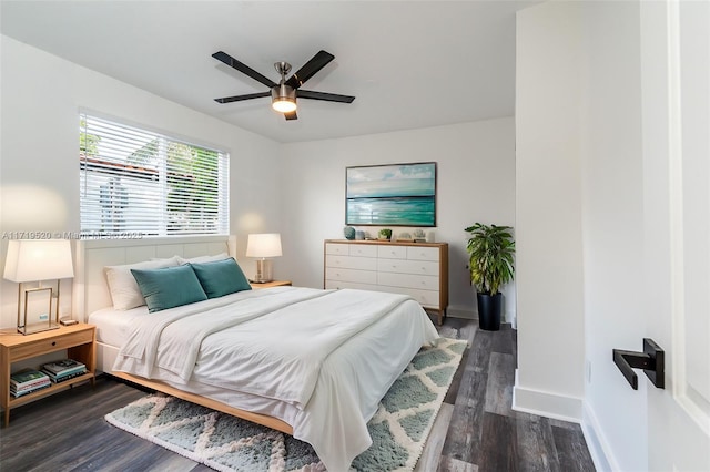 bedroom featuring a ceiling fan, dark wood finished floors, and baseboards