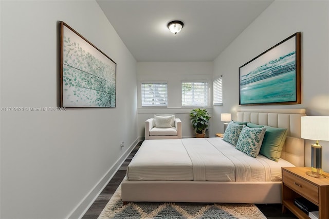 bedroom with dark wood-style floors and baseboards