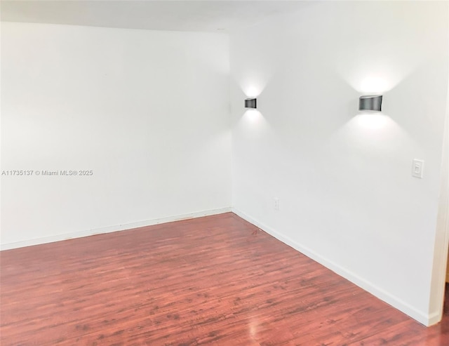 empty room with dark wood-type flooring