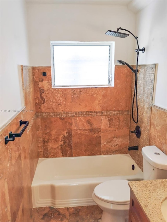 full bathroom featuring tile walls, vanity, toilet, and a healthy amount of sunlight