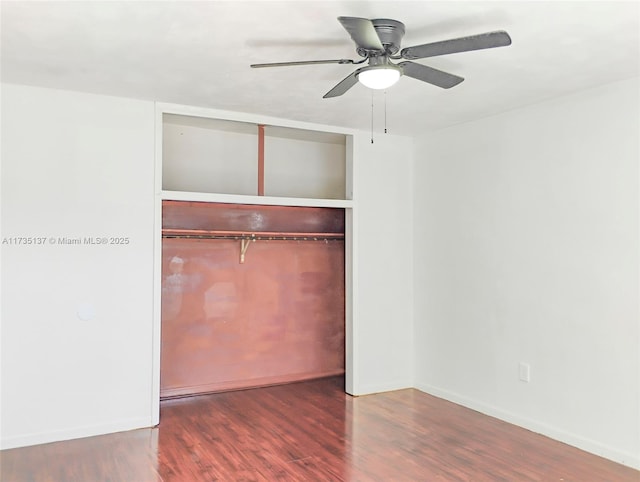 unfurnished bedroom with ceiling fan, wood-type flooring, and a closet