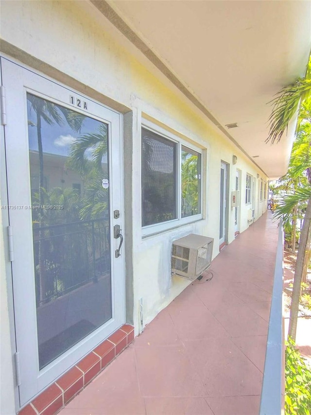 doorway to property with a wall mounted AC