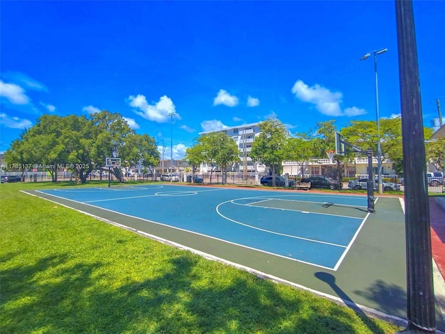 view of basketball court featuring a yard