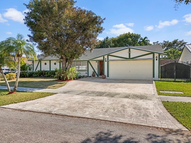 ranch-style home featuring a garage and a front yard