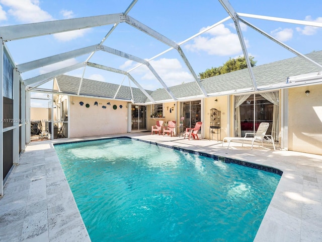 view of pool with a lanai and a patio