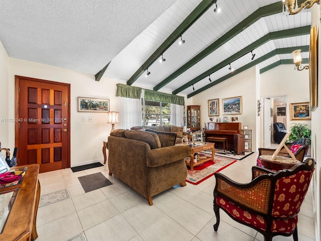 living room with light tile patterned flooring, rail lighting, vaulted ceiling with beams, and a textured ceiling