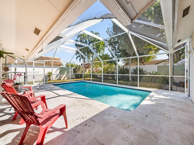 view of pool featuring a patio area and glass enclosure