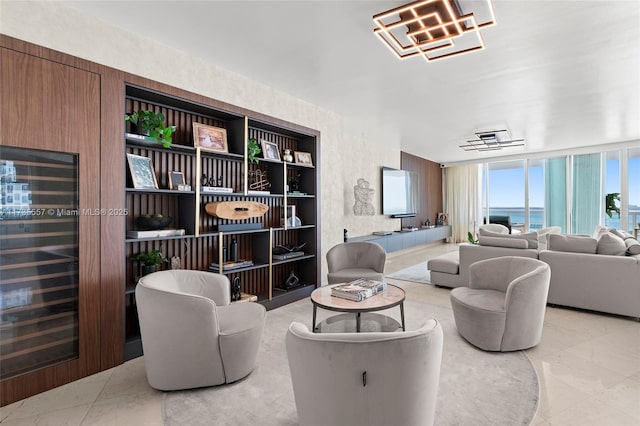 living room featuring wine cooler and a wall of windows