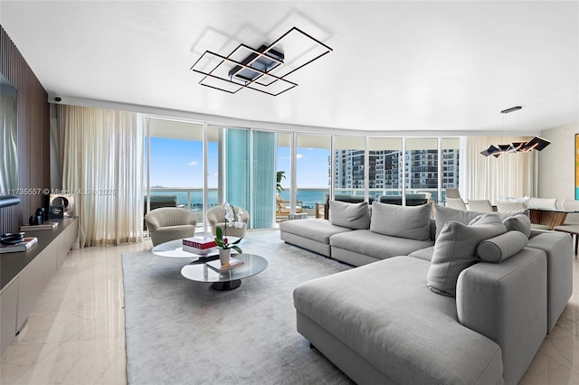 living room with floor to ceiling windows and a water view