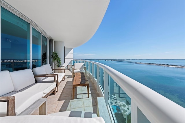 balcony featuring a water view and an outdoor hangout area