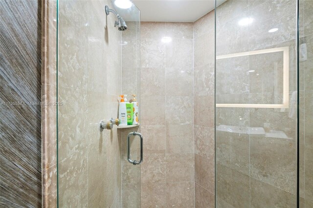 bathroom featuring a shower with shower door