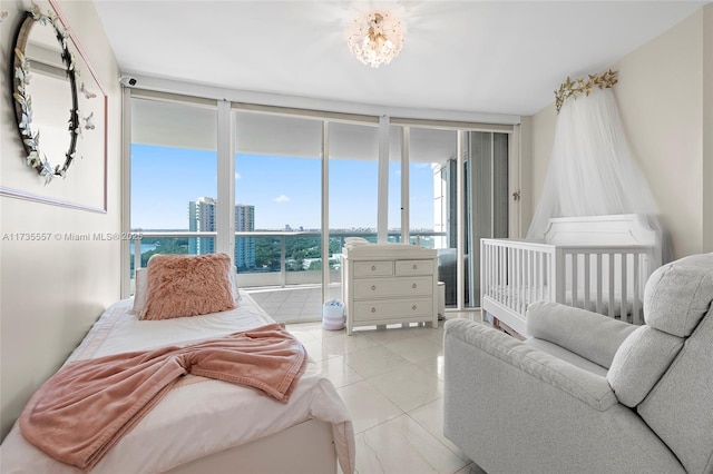 tiled bedroom featuring floor to ceiling windows