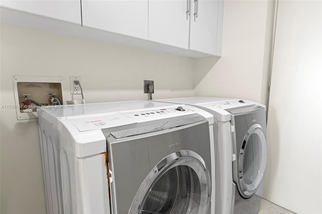 laundry area featuring independent washer and dryer and cabinets