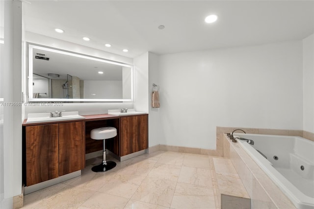 bathroom featuring vanity and shower with separate bathtub