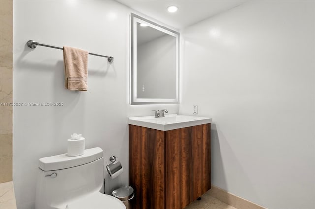 bathroom with vanity, tile patterned floors, and toilet