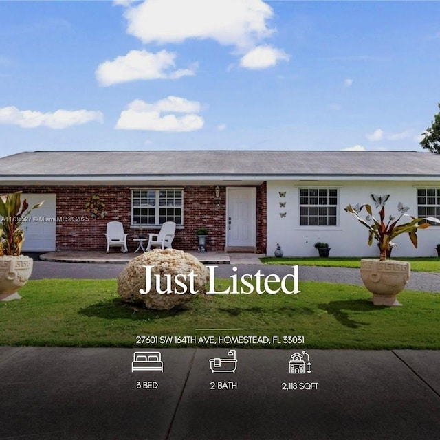 single story home with a garage and a front yard