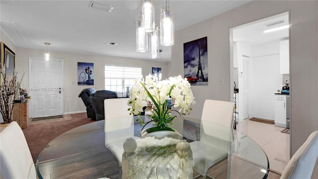 dining space featuring light colored carpet