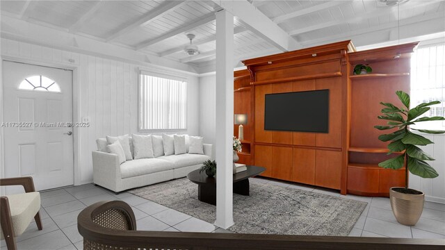 living room featuring vaulted ceiling with beams, light tile patterned floors, and ceiling fan