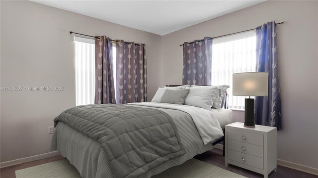 bedroom with dark colored carpet