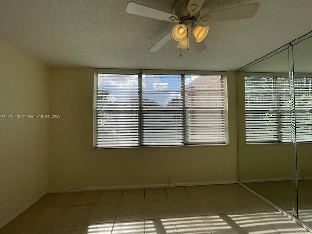 unfurnished sunroom featuring ceiling fan
