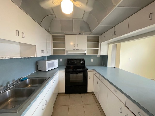 kitchen with sink, electric range, light tile patterned floors, and white cabinets