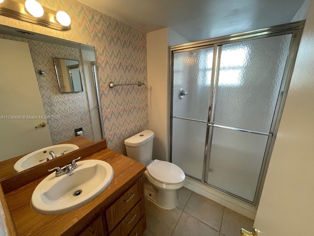 bathroom featuring walk in shower, tile patterned floors, vanity, and toilet