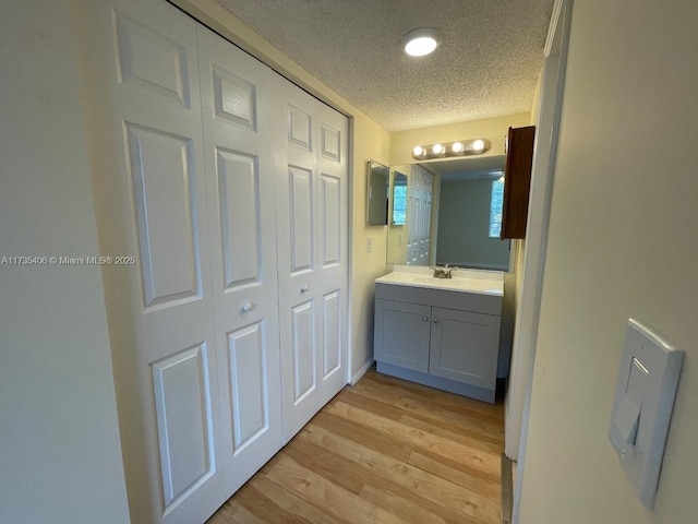 bathroom with vanity, hardwood / wood-style flooring, and a textured ceiling