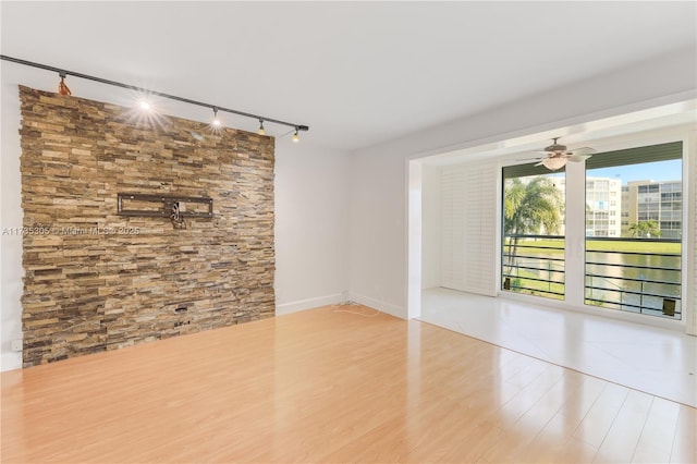 spare room with light hardwood / wood-style floors and ceiling fan