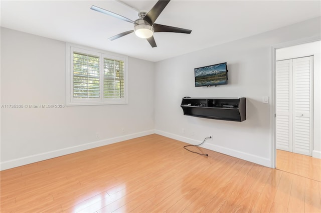 interior space featuring wood-type flooring and ceiling fan