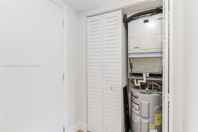 utility room featuring water heater