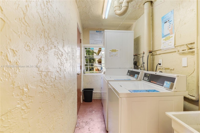 laundry area featuring washing machine and dryer and sink