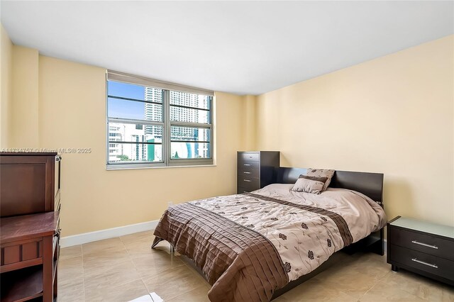 unfurnished living room with light tile patterned floors and a wall of windows